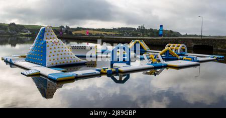 Floating activity centre reflecting in early morning still waters Stock Photo