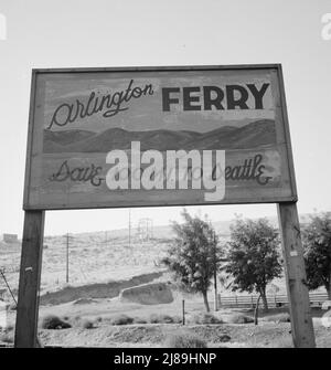 On transportation outskirts of small Oregon town on the Columbia River. Arlington, Gilliam County, Oregon. [Sign: 'Arlington Ferry - Save 100 Mi(les) to Seattle']. Stock Photo