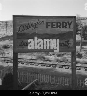 On transportation outskirts of small Oregon town on the Columbia River. Arlington, Gilliam County, Oregon. [Sign: 'Arlington Ferry - Save 100 Mi(les) to Seattle']. Stock Photo