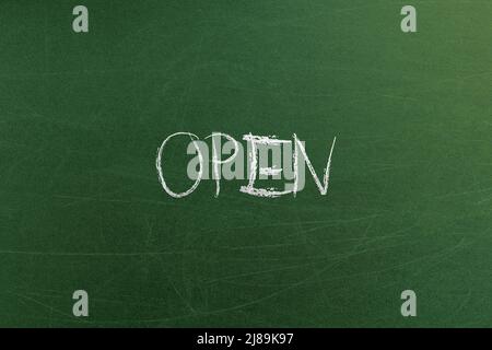 Green chalkboard with open word placard in cafe. Banners and signs templates and concepts Stock Photo