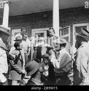 Daytona Beach, Florida. Bethune-Cookman College. Mrs. Shaw handing out mail to college and NYA (National Youth Administration) students in front of the boys' dormitory. Stock Photo