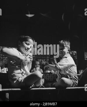 New Britain, Connecticut. A child care center, opened September 15, 1942, for thirty children, age two to five, of mothers engaged in war industry. The hours are 6:30 a.m. to 6 p.m. six days per week. &quot;Milk time&quot; at the center. Stock Photo