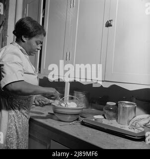 New Britain, Connecticut. A child care center opened September 15, 1942, for thirty children, ages two through five of mothers engaged in war industry. The hours are 6:30 a.m. to 6 p.m. six days per week. The dietician preparing a meal. Stock Photo