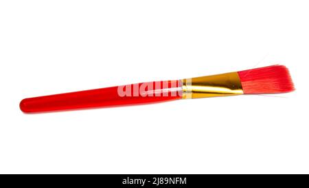 Red plastic brush for paint isolated on the white background Stock Photo