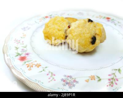 cranberry scone cookies on the beautiful flower dish isolated on white background Stock Photo