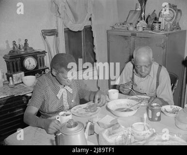 Washington, D.C. Elderly couple eating dinner at their home on Lamont Street, N.W.. Stock Photo