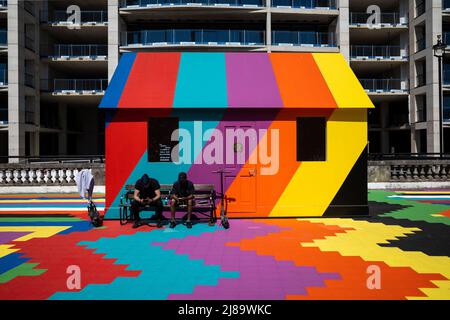 London, UK.  14 May 2022.  UK Weather – Visitors in the sunshine at the colourful Lakwena’s “Artist’s Garden” above Temple tube station.  Temperatures in the capital are forecast to rise to 22C. Credit: Stephen Chung / Alamy Live News Stock Photo