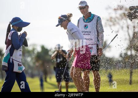 BANG KAPONG THAILAND - May 14:  Manon De Roey of Belgium tries to hide from a spray of champagne and water after winning the Aramco Team Series (individual) at Thai Country Club on May 14, 2022 in Bang Kapong, Thailand (Photo by Orange Pictures) Stock Photo