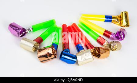 Party different many foil whistle horns noisemaker isolated on the white background Stock Photo