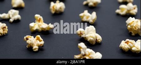 Popcorn on an black background, close-up, long banner Stock Photo