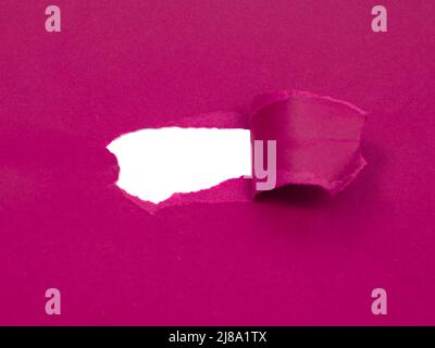 Red marsala paper damaged torn with white hole isolated copyspace for text Stock Photo