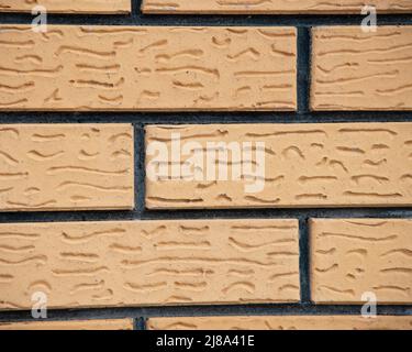 Yellow decorative bricks wall textured background Stock Photo
