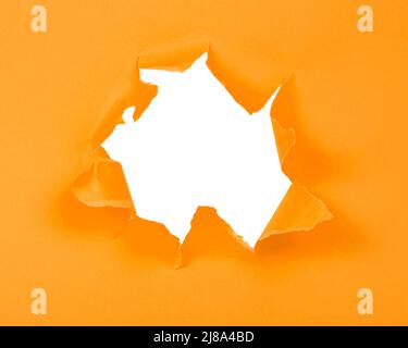 Orange crushed torn paper with hole copyspace background for idea Stock Photo