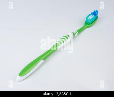 Green toothbrush for teeth on the white background Stock Photo