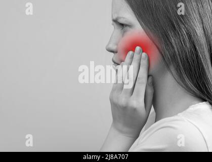 Toothache, teeth pain concept. Woman holding cheek with teeth aching. High quality photo Stock Photo