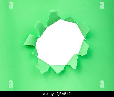Green color paper with circle hole in damaged background Stock Photo