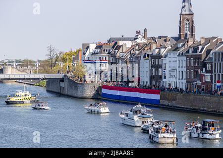 Maastricht, South Limburg, Netherlands. April 27, 2022. King's day celebration in Holland, boats and happy people celebrating and enjoying, sunny spri Stock Photo