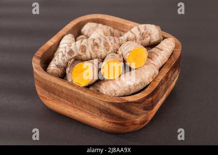 Roots of turmeric (Curcuma longa) Photo on dark background. Stock Photo