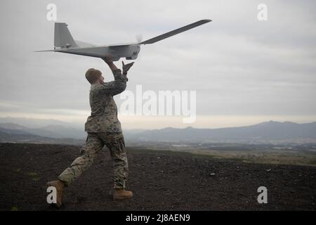 U.S. Marine Corps Cpl. Jared Hipke, with 1st Battalion, 3d Marines, 3d Marine Division launches an RQ-20B Puma fixed wing unmanned aerial system at Combined Arms Training Center, May 4, 2022 in Camp Fuji, Japan. Stock Photo