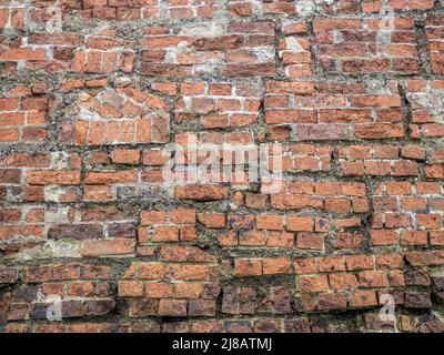 Very old brick wall, rebuilt. Background. Stock Photo