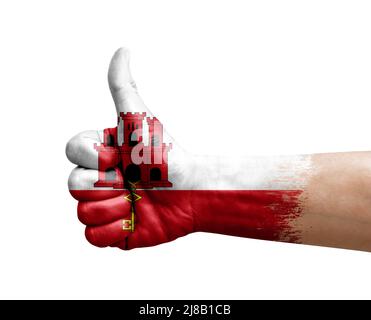 Hand making thumb up painted with flag of gibraltar Stock Photo