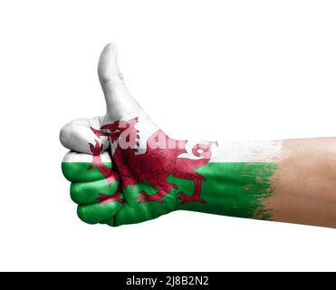 Hand making thumb up painted with flag of wales Stock Photo