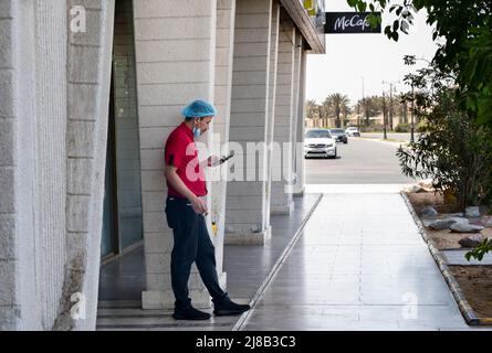 Jeddah, Saudi Arabia. 14th May, 2022. A worker stands outside the American multinational fast-food Mcdonald's order counter in Jeddah. (Photo by Budrul Chukrut/SOPA Images/Sipa USA) Credit: Sipa USA/Alamy Live News Stock Photo