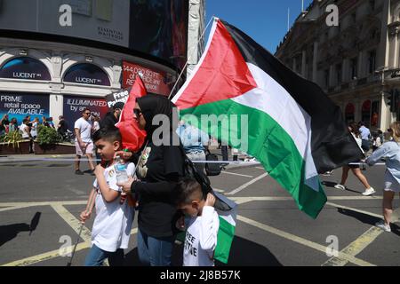 London, United Kingdom. 14th May, 2022. People marched from the BBC to Downing Street to mark Nakba Day, or the Day of Keys marked by the Palestinian community in London. People also stood in solidarity in sadness and anget at the recent shooting of a Palestinian journalist. Credit: Natasha Quarmby/Alamy Live News Stock Photo