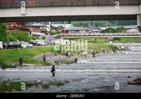 iida, nagano, japan, 2022/15/05 , People fishing during an event at Matsugawa river in Iida city in Nagano, Japan. Stock Photo