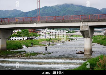 iida, nagano, japan, 2022/15/05 , People fishing during an event at Matsugawa river in Iida city in Nagano, Japan. Stock Photo