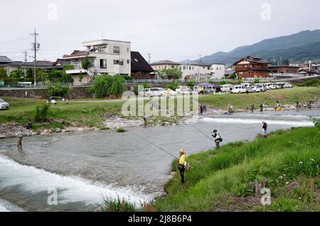 iida, nagano, japan, 2022/15/05 , People fishing during an event at Matsugawa river in Iida city in Nagano, Japan. Stock Photo