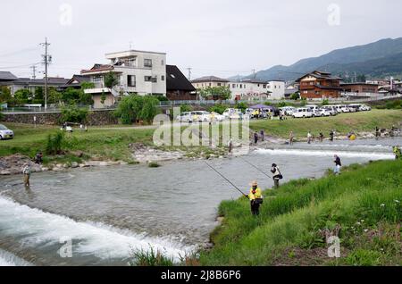 iida, nagano, japan, 2022/15/05 , People fishing during an event at Matsugawa river in Iida city in Nagano, Japan. Stock Photo