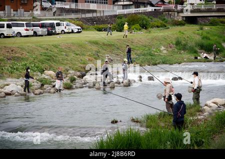 iida, nagano, japan, 2022/15/05 , People fishing during an event at Matsugawa river in Iida city in Nagano, Japan. Stock Photo