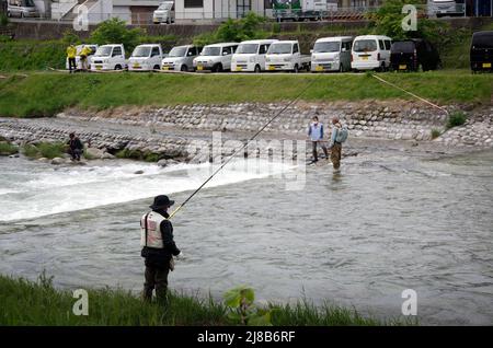 iida, nagano, japan, 2022/15/05 , People fishing during an event at Matsugawa river in Iida city in Nagano, Japan. Stock Photo