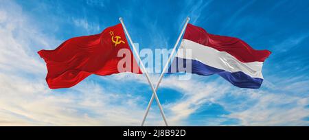 two crossed flags ussr and Netherland waving in wind at cloudy sky. Concept of relationship, dialog, travelling between two countries. 3d illustration Stock Photo