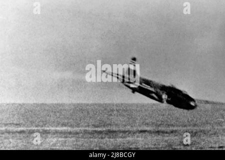 An Imperial Japanese Navy Mitsubishi G4M 'Betty' bomber plunges towards the water after being shot down during an engagement with U.S. Navy Grumman F4F-3 Wildcat fighters from Fighting Squadron VF-3 defending the aircraft carrier USS Lexington (CV-2) off Rabaul, New Britain, in February 1942. Stock Photo