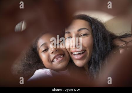 African woman her daughter showing love symbol to camera Stock Photo