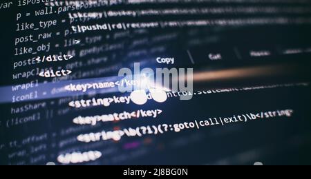 Abstract computer script code. Programming code screen of software developer. Software Programming Work Time. Stock Photo