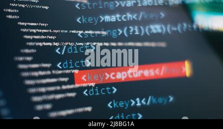 Website HTML Code on the Laptop Display Closeup Photo. Modern tech. Innovative startup project. Stock Photo