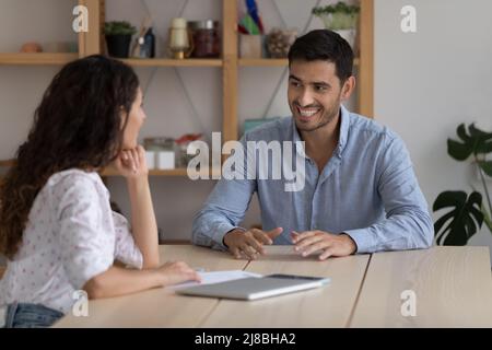 Happy confident mentor training intern, teaching student, smiling Stock Photo