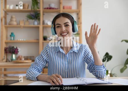 Happy young business blogger in wireless headphones giving webinar Stock Photo