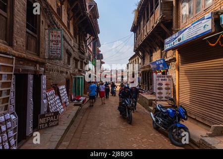 Bhaktapur, Nepal - October 29, 2021: City in the east corner of the Kathmandu Valley in Nepal. Street view of the narrow streets with the badly dilapi Stock Photo