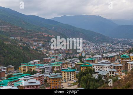 Thimphu, Bhutan - October 26, 2021: Aerial view cityscape of Bhutan capitol city. Top view with dramatic cloudy sky over the town. Largest city in Bhu Stock Photo