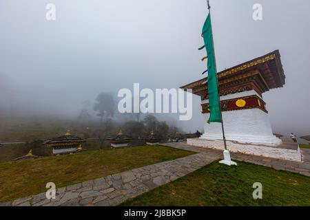 Bhutan, October 26, 2021: Druk Wangyal, Bhutan, 108 chorten or stupas, memorial in honor of the Bhutanese soldiers at the Dochula Pass. Cloudy foggy d Stock Photo