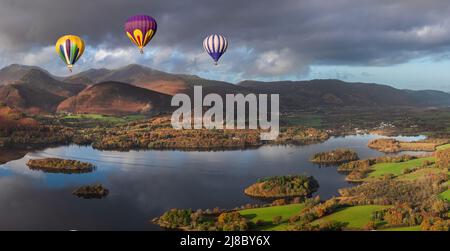 Digital composite image of hot air balloons over Epic landscape Autumn image of view from Walla Crag in Lake District, over Derwentwater looking towar Stock Photo