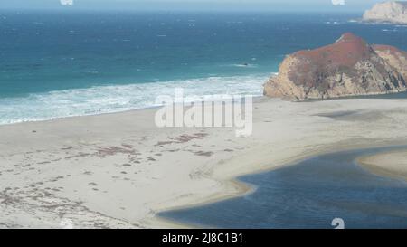 Little sur river beach on Pacific Coast Highway 1, scenic Cabrillo road. Estuary of river flowing to sea. Waves crashing on shore. Turning, winding, twisting creek. Big Sur landscape, California, USA. Stock Photo