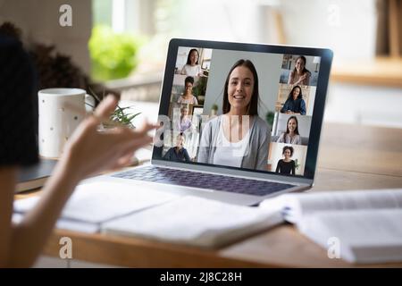 Employee talking to coworkers on Internet conference, using laptop Stock Photo