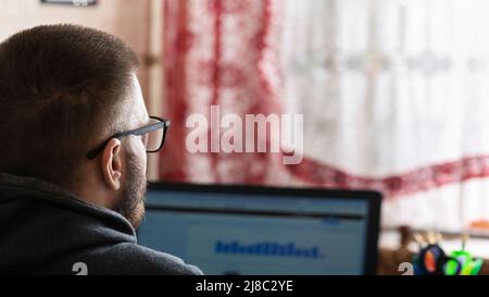 Young freelancer working at a computer at home, work remote from the office, home office Stock Photo