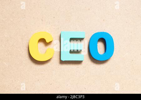 Color alphabet letter in word CEO (Abbreviation of Chief Executive Officer) on wood background Stock Photo