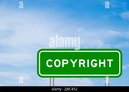 Green color transportation sign with word copyright on blue sky with white cloud background Stock Photo